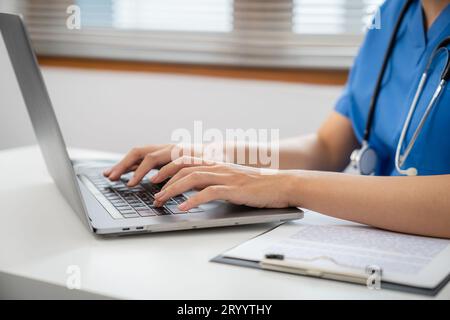 Medical technology network team meeting concept. doctor hands typing on keyboard laptop computerÂ Stock Photo