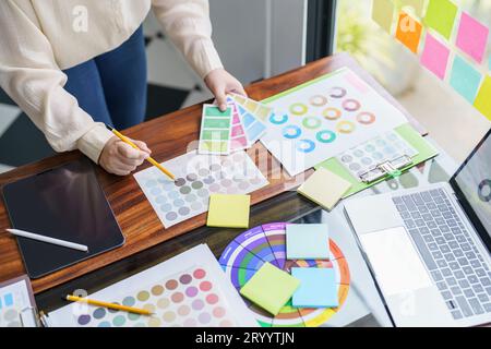 Creative idea Business female Artist Creative Designer sketch graphic drawing on graphic tablet and Color swatch samples Concept Stock Photo