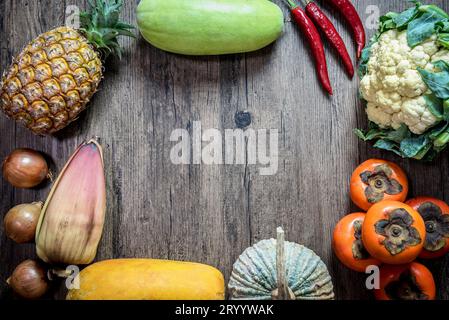 Asia tropical organic natural chemical free fruits and vegetables (pineapple, pumpkin and chili,etc) display on wooden backgroun Stock Photo