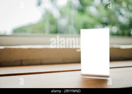 Mock up Menu frame standing on wood table in Bar restaurant cafe. space for text. Stock Photo