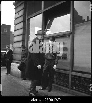 Cincinnati, Ohio, USA. circa 1937.  Men waiting in front of a building of the Employment Center office during depression era.. Archive Photograph in 1930s by Annemarie Schwarzenbach of depression America Stock Photo