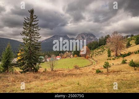 Picturesque view of the Durmitor mountain range under a dramatic cloudy sky during the fall season in Montenegro Stock Photo