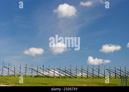 Small, white clouds against a blue sky. Stock Photo