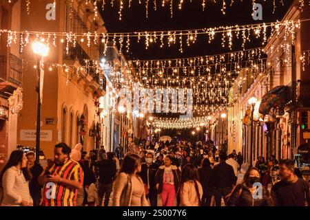 Christmas lights at night hanging in the city during the holidays Stock Photo