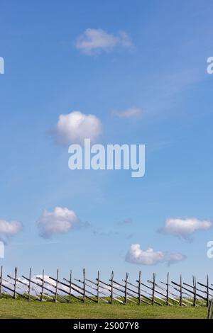Small, white clouds against a blue sky. Stock Photo