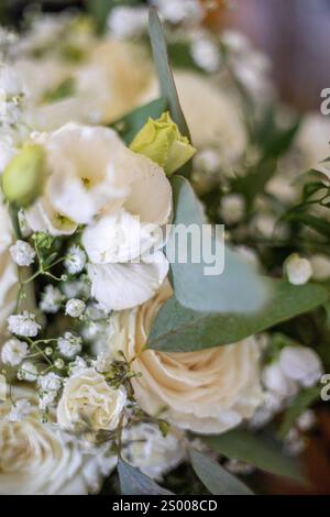 Close-up of white roses, greenery, and delicate baby's breath Stock Photo