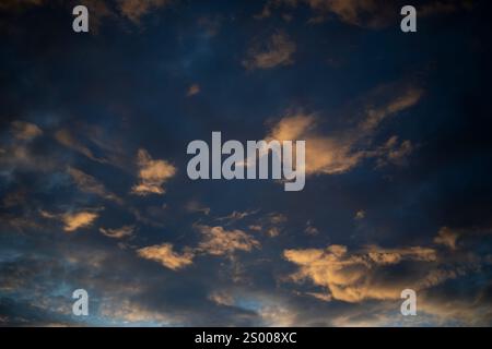 The setting sun illuminated the clouds. The light on the clouds. Stock Photo