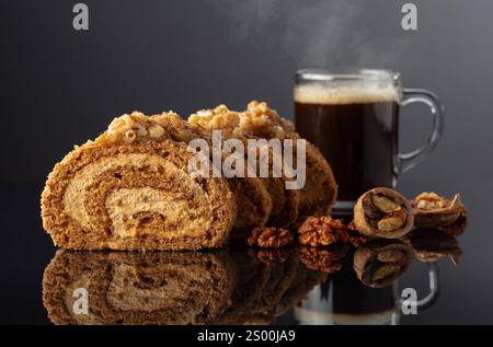 Dessert with walnuts and coffee on a black reflective background. Cake with brown sugar, walnuts, and cream. Copy space. Stock Photo