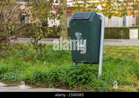 Utrecht, the Netherlands. 26 October 2024. Green trash can basket, Dispose dog waste in a trash can. Responsibility for people around the environment. Stock Photo