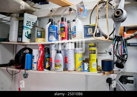 Manchester, UK, 01, December, 2024: Assorted car maintenance products on shelves in a garage workshop. Stock Photo