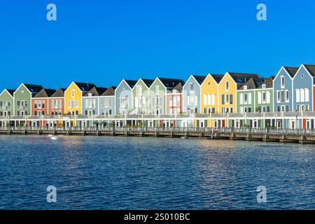 Skyline of Houten with famous Rainbow Houses in the Netherlands. Morning blue sky. Stock Photo