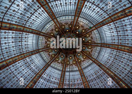 Paris, France - 12 12 2024: View of a Huge Christmas tree that decorates the center of the dome inside a famous Parisian department store. Stock Photo