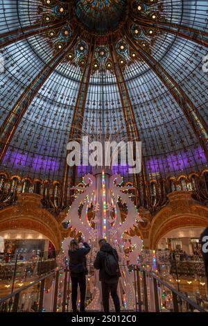 Paris, France - 12 12 2024: View of a Huge Christmas tree that decorates the center of the dome inside a famous Parisian department store. Stock Photo