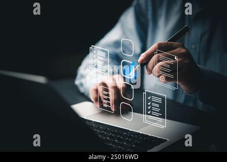 Person digital checklist document approve business.Quality assurance on a laptop, task management, productivity, and planning. Useful for project mana Stock Photo