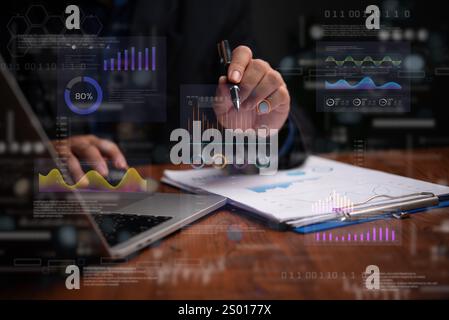 Hand analyzing financial and statistical data through holographic graphs and charts. Highlights business intelligence, performance tracking, and trend Stock Photo