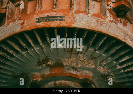 Rusty wheeled surface of old metal wheel surface. Broken vintage mechanism. Steel gear. Turbine blade with rusted surface with corrosion and rusting . Stock Photo