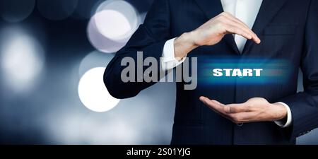 Businessman hand touching START on virtual screen Stock Photo