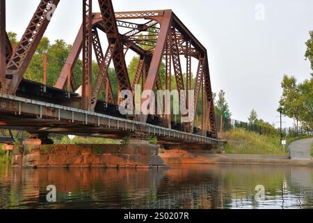 Sherbrooke Nation Lake train bridge. Steel truss bridge for train tracks. Lac des Nations. Stock Photo
