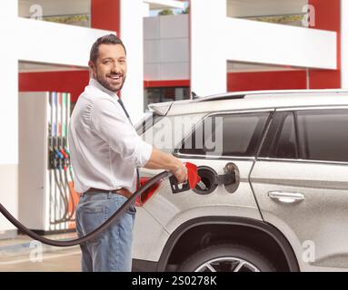 Man filling a car with petrol at a self service gas station Stock Photo