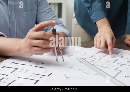 Architects working with project, closeup. Different technical drawings on table Stock Photo