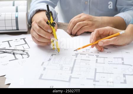 Architects working with project, closeup. Different technical drawings on wooden table Stock Photo