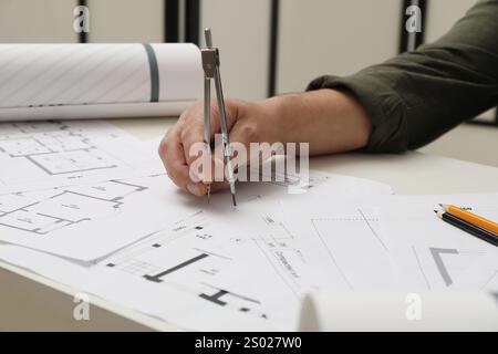 Architect working with project, closeup. Different technical drawings on table Stock Photo