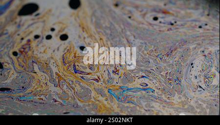 Psychedelic dye. Soap bubbles. Defocused multicolor purple green liquid paint oil rainbow curve acrylic slick on dark black blurred light abstract art background. Stock Photo