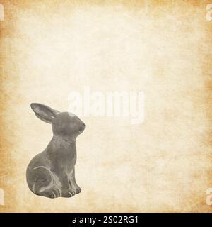 cute cement rabbit statue for decorate isolated on a grunge vintage texture background Stock Photo