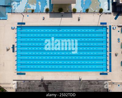 Aerial view of swimming pool with marked lanes and swimmers. Stock Photo