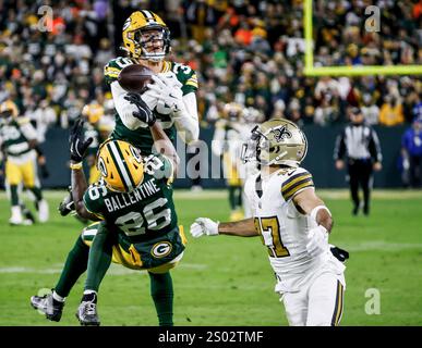 Green Bay, United States. 23rd Dec, 2024. Green Bay Packers safety Zayne Anderson (Top) and Green Bay Packers cornerback Corey Ballentine (Bottom) break up a pass intended for New Orleans Saints wide receiver Dante Pettis (R) during the NFL game between the New Orleans Saints and the Green Bay Packers at Lambeau Field in Green Bay, Wisconsin on Monday, December 23, 2024. The Packers shut out the Saints 34-0. Photo by Tannen Maury/UPI Credit: UPI/Alamy Live News Stock Photo