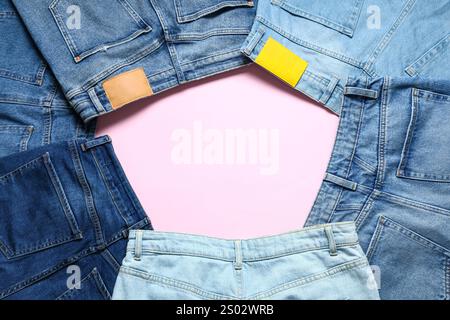Frame made of jeans pants on pink background Stock Photo