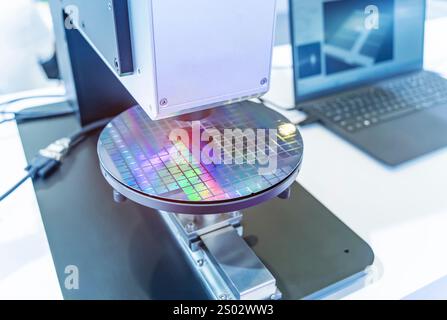Silicon wafer with semiconductor microchip on machine process examining testing in microscope. Stock Photo