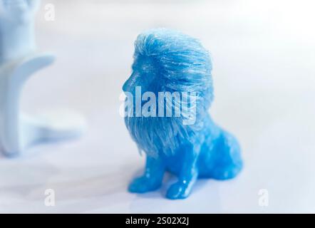 3D printer printing blue lion figure close-up. Stock Photo