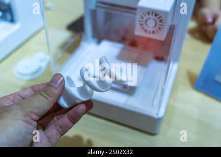 hand with spiral object printed on 3d printer close-up Stock Photo
