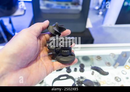 hand with Object of gear printed on 3d printer close-up Stock Photo