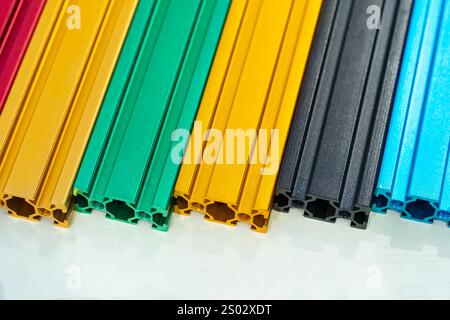 Various colorful samples of aluminum profile on the stand. Industry Stock Photo