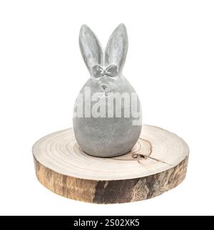 cute cement rabbit statue for decorate on round wood textured background isolated on white Stock Photo