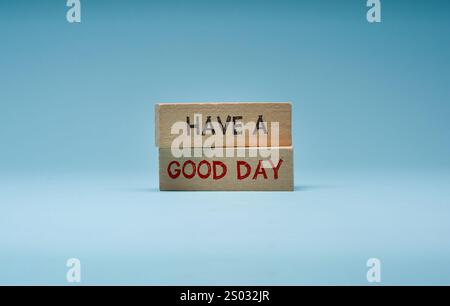 Have a good day is written on wooden blocks standing on a blue background Stock Photo