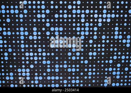 View of the sky through a punctured metal grille Stock Photo
