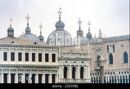 A close-up view of the ornate domes and architecture of St. Mark's Basilica in Venice, Italy, featuring intricate details and a cloudy sky. Stock Photo