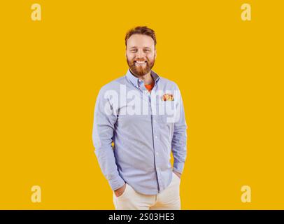 Portrait of a Smiling Bearded Man on an Orange Background Stock Photo