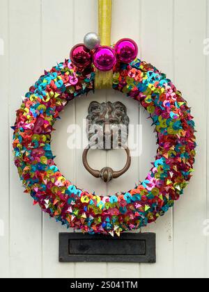 A colourful home-made Christmas wreath hanging on a front door (UK) Stock Photo