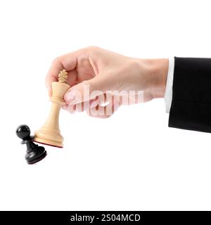 Man with white chess king knocking over black pawn on white background, closeup. Competition concept Stock Photo