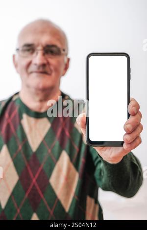 Old Man holding screen smartphone on empty white background. High quality photo Stock Photo