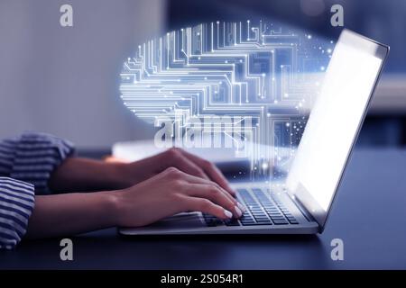 Businesswoman working on laptop at desk, closeup. Digital brain coming out of computer symbolizing artificial intelligence Stock Photo