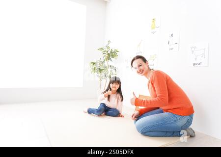 Children taking lessons from a native teacher in an English language classroom Stock Photo