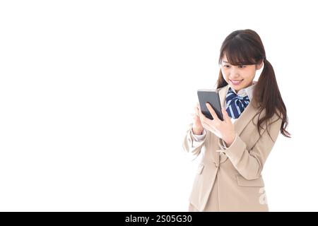 Student in school uniform using a smartphone Stock Photo