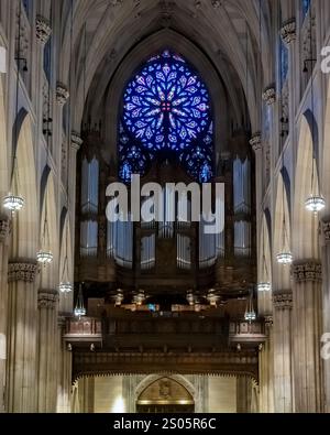 The breathtaking interior of St. Patrick's Cathedral in NYC showcases its magnificent rose window, vaulted ceilings, and intricate gothic architecture Stock Photo