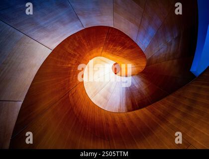 Abstract spiral staircase at the Art Gallery of Ontario in Toronto, showcasing stunning curves, light, and shadow in a harmonious architectural design Stock Photo