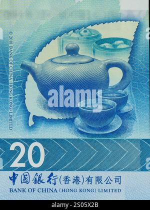 Portrait of teapot with cup from Hong Kong 20 dollar bank of China vertical currency note. Stock Photo